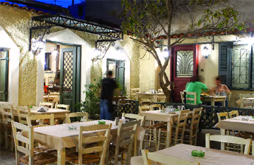 Kappari taverna in Petralona — outdoor courtyard dining under trees